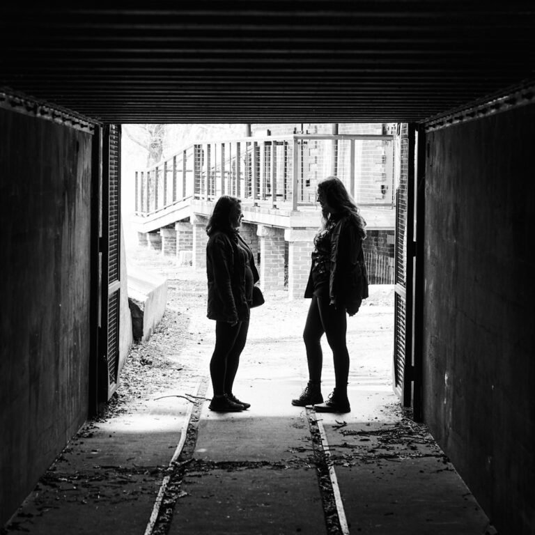 Two people talking face-to-face, illustrating respectful assertive communication