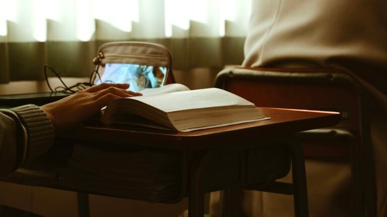 Laptop and notebook in a workspace illustrating classroom behavior tracking apps