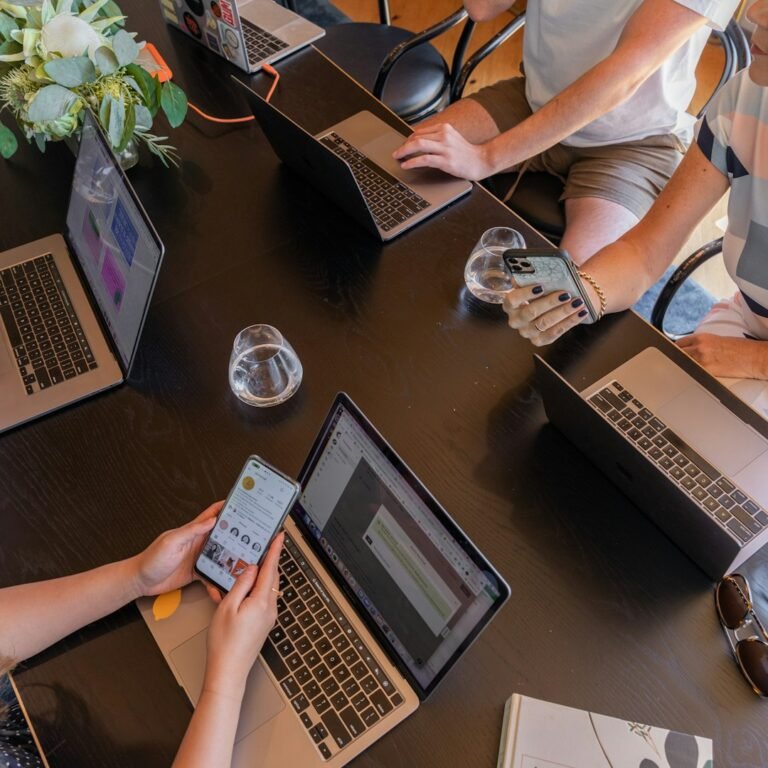 People collaborating around a table to develop solutions together