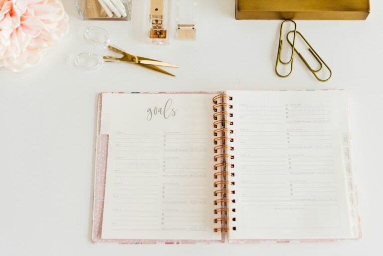 Open spiral notebook and writing materials used for classroom behavior recording